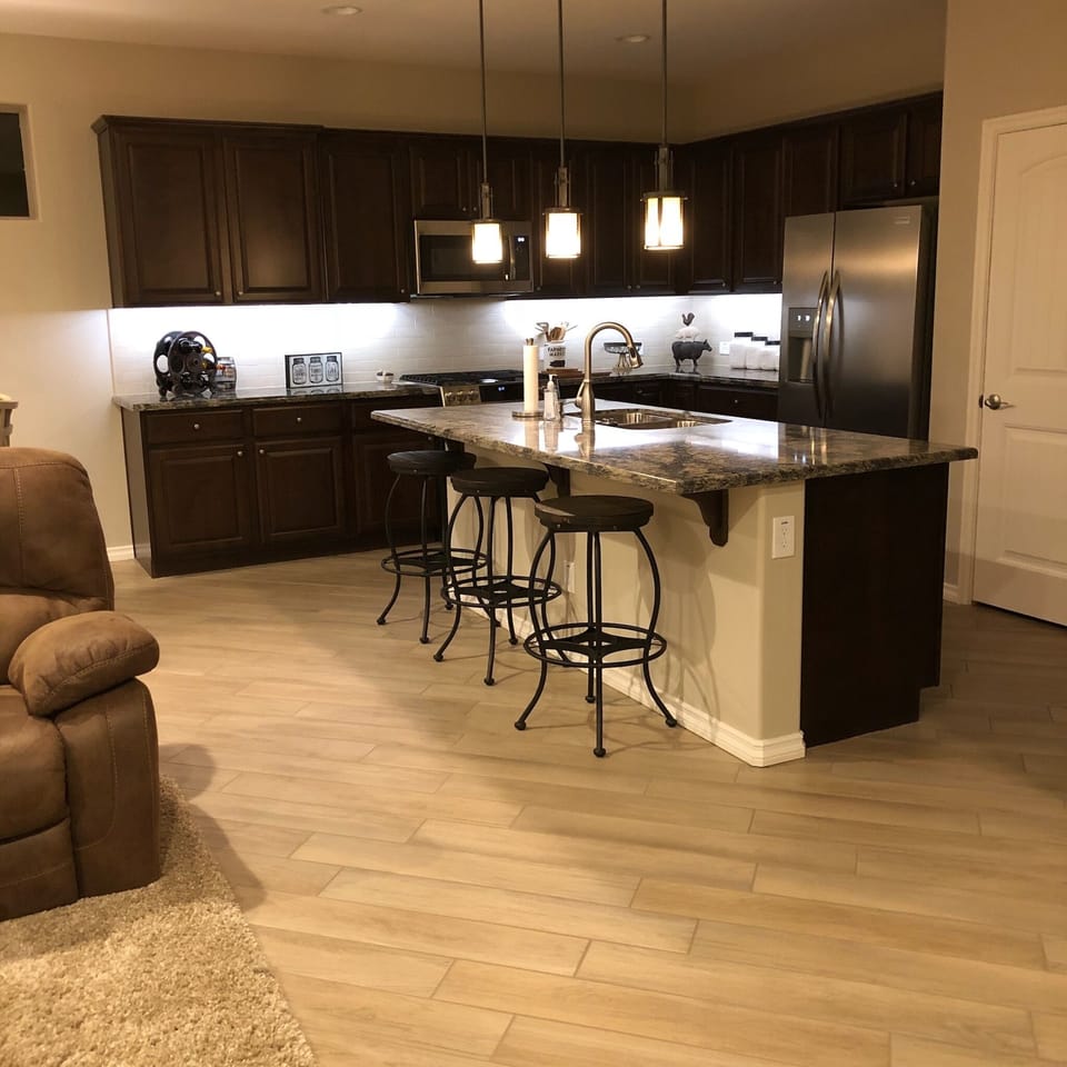Spacious kitchen, fully equipped with dishes, pans, coffee maker, and toaster.