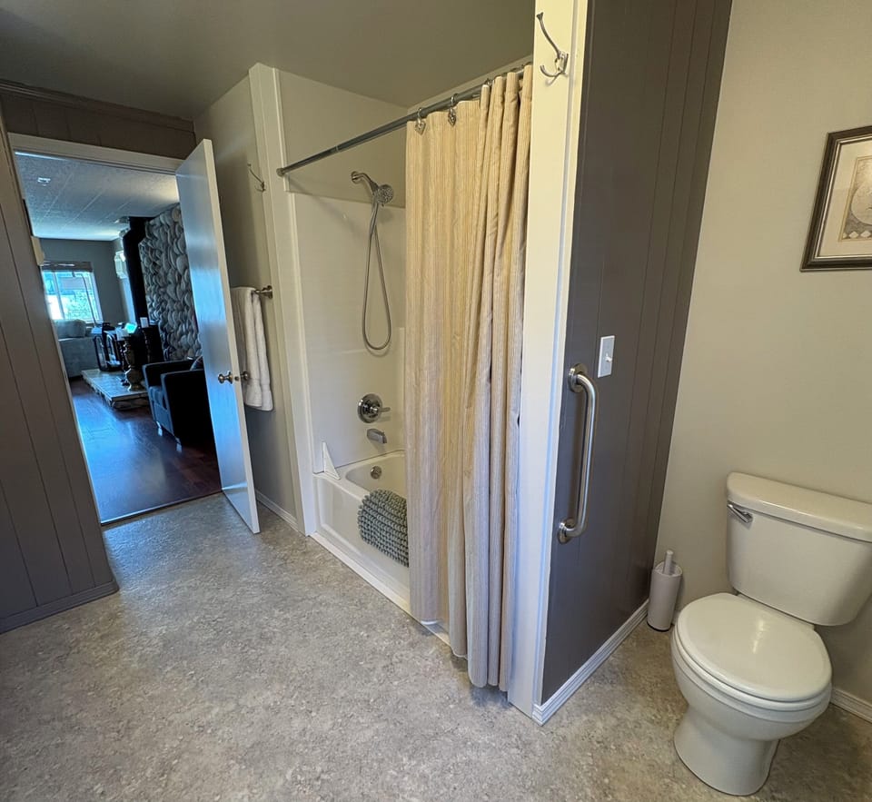 Main bath. Off living room. Grab bars