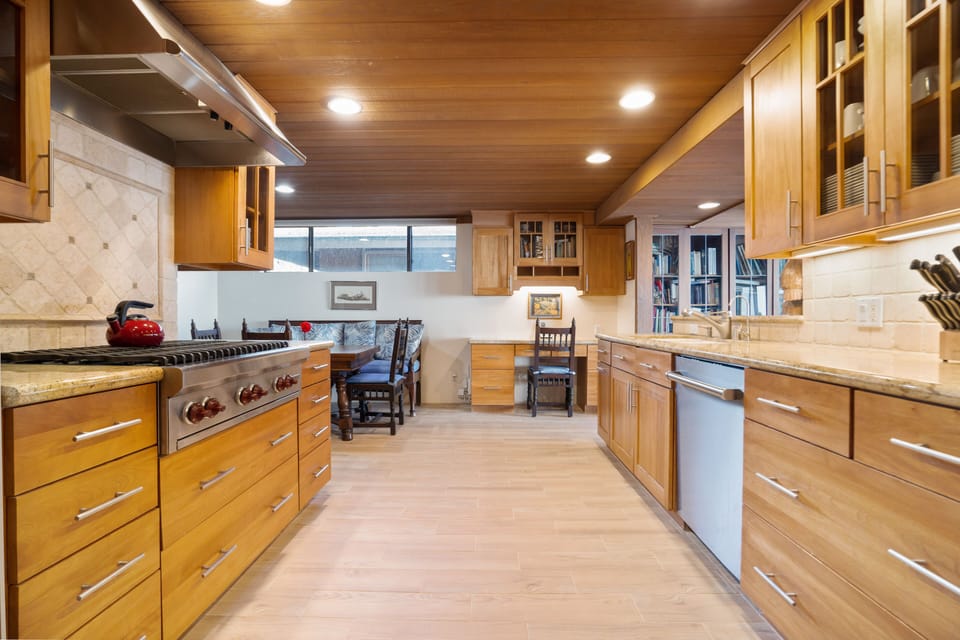 UPGRADED KITCHEN WITH WOLF, SUBZERO & ASKO APPLIANCES WITH WORK STATION FAR WALL