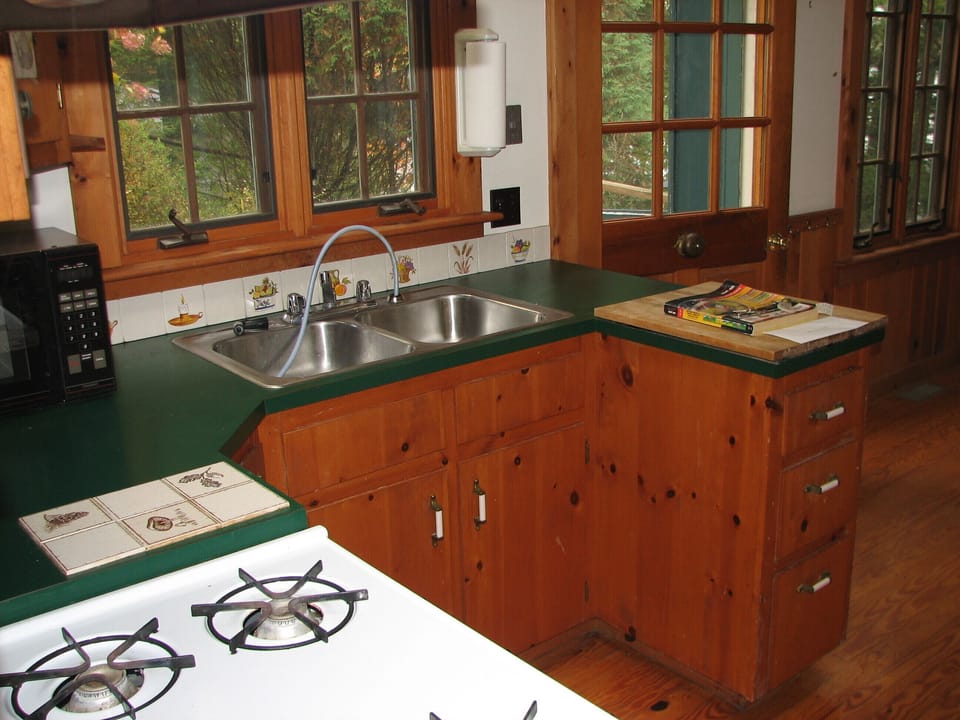 Kitchen with gas range and microwave