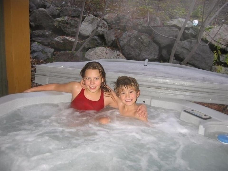 Our kids enjoying the private hot tub. Nice and secluded with relaxing jets