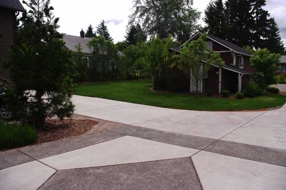 View from house to common green space area.  BBQ and chairs available for use.