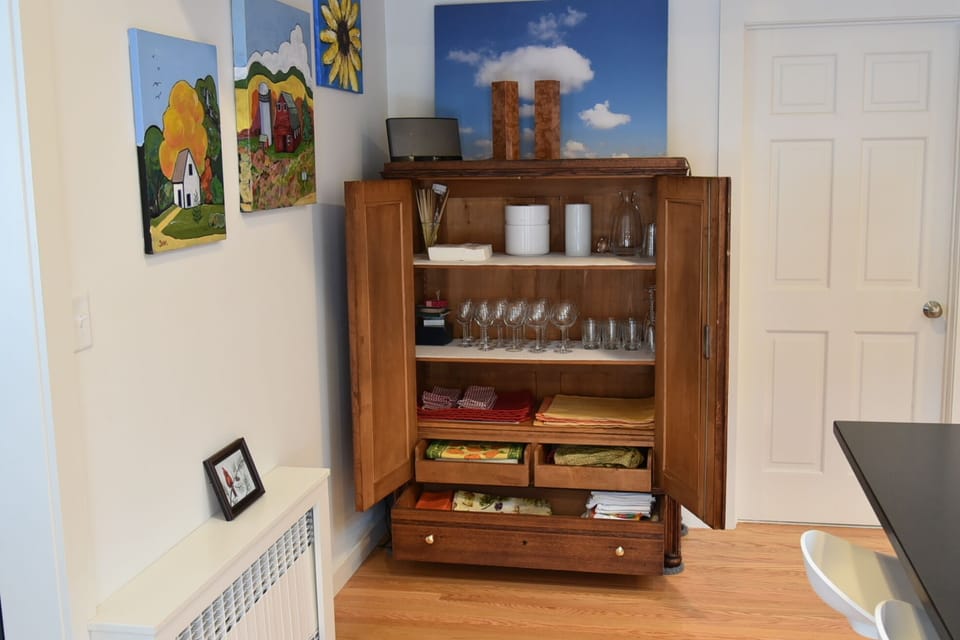 Kitchen side cabinet thats hiding behind the huge hydrangea bouquet.
