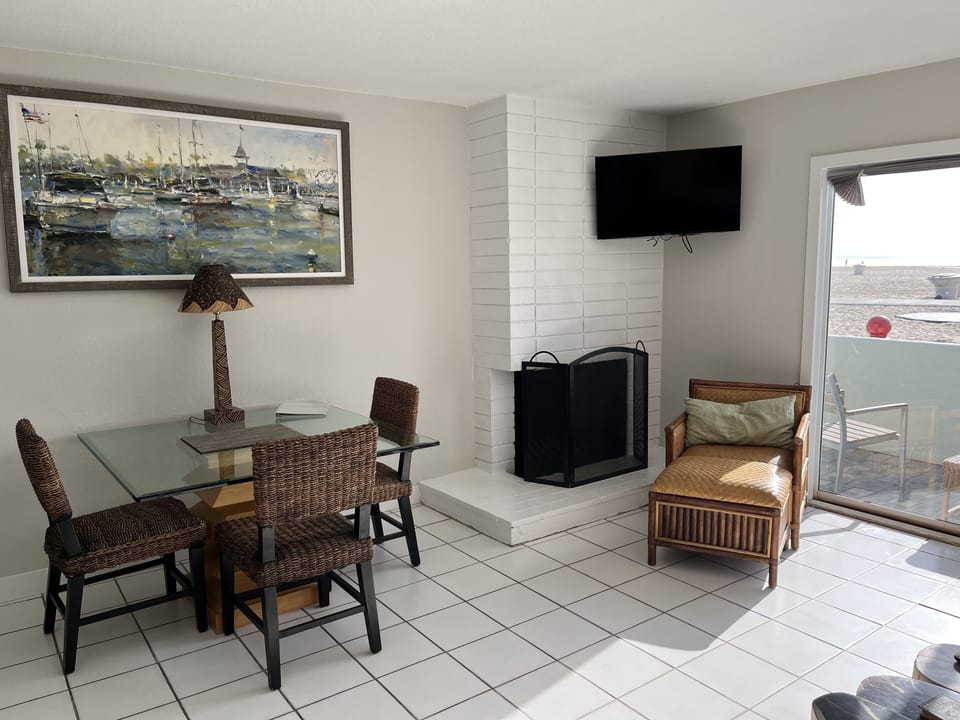 Tommy Bahama dining table, fireplace and TV