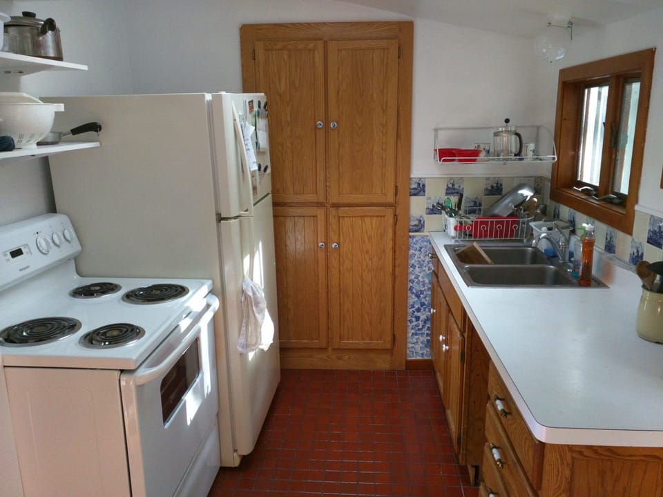 Kitchen with ample storage shelves and range.