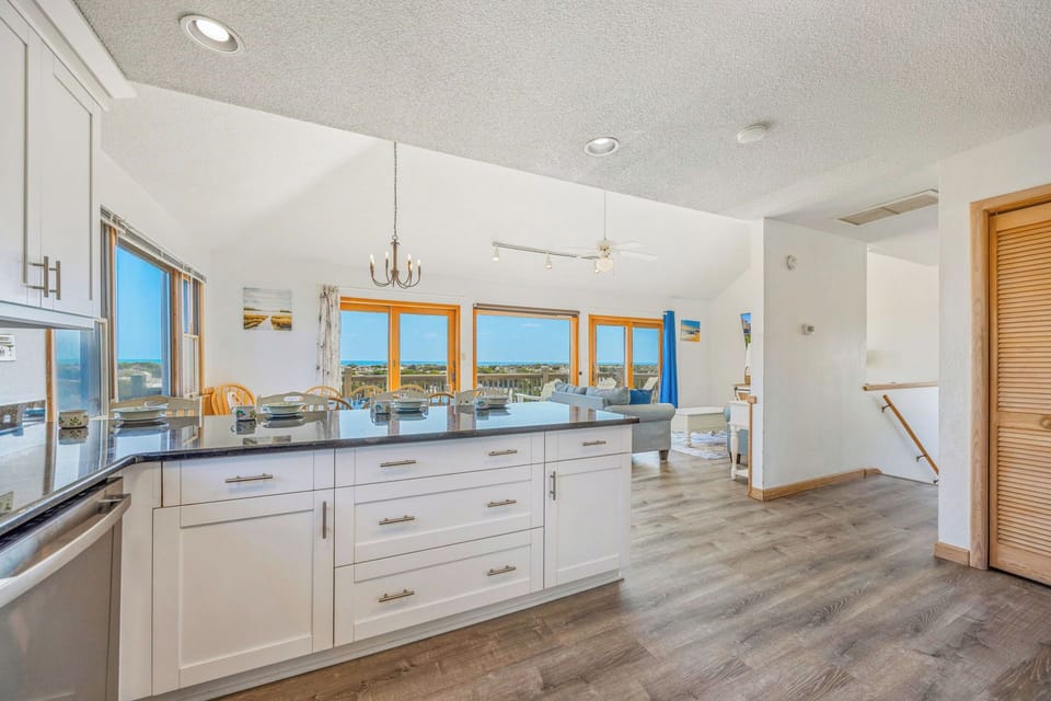 Step into this bright, open space where natural light pours through stunning windows, revealing sweeping views. The modern kitchen flows into your inviting living area, perfect for relaxing and entertaining.