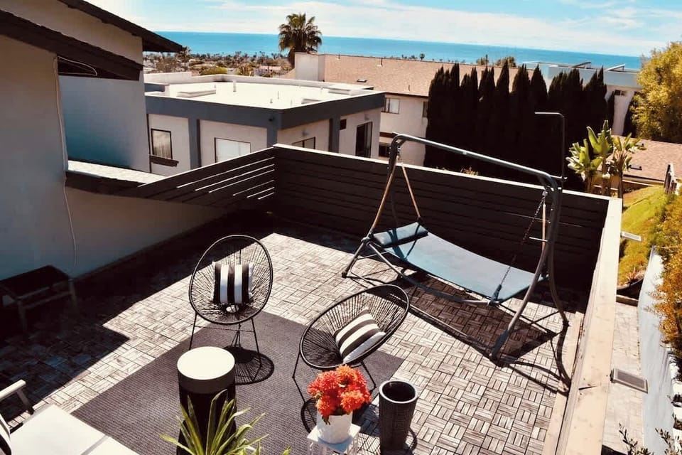 REAR UPSTAIRS BEDROOM ROOFTOP DECK WITH AN OCEAN VIEW