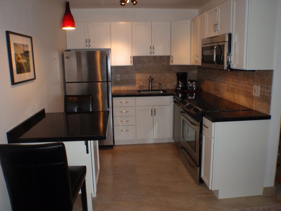 The kitchen has new porcelain floor, new cabinets & countertops, new appliances