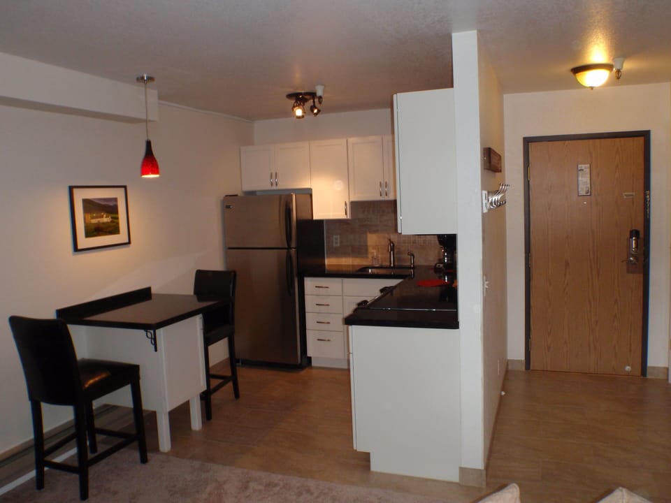 Kitchen is stocked with dishes, cookware, and utensils necessary for meal prep.