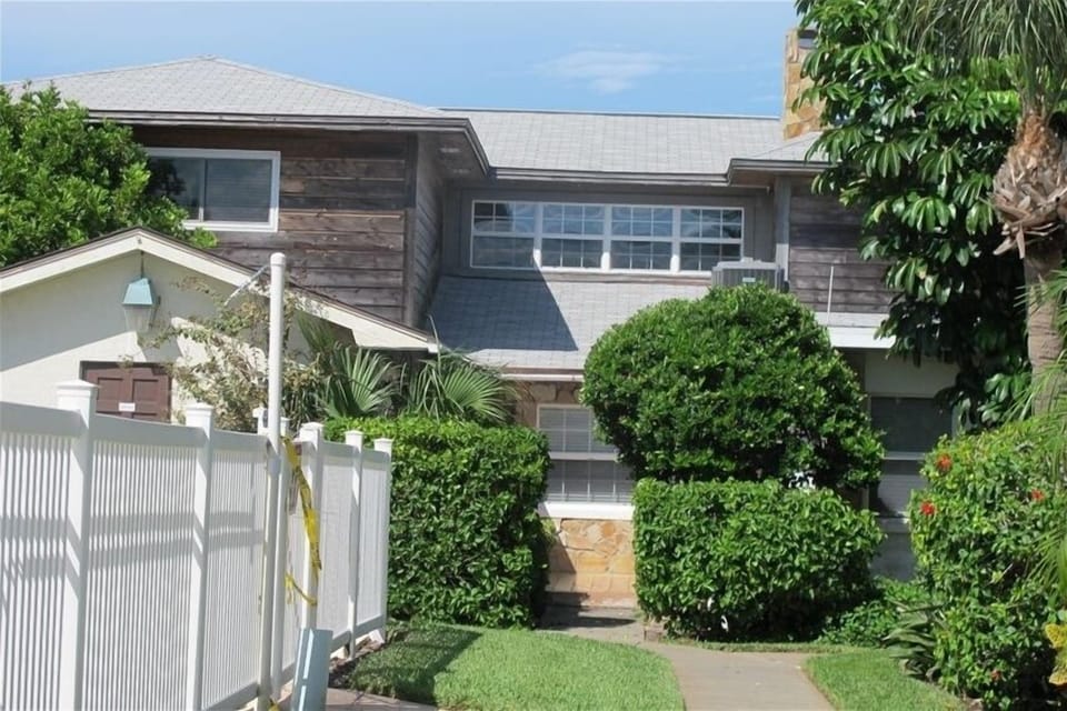 view of front of house and pool our unit is the the left side of the property
