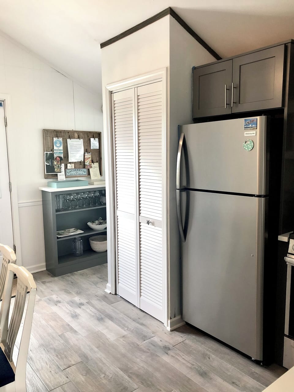 Full fridge & stackable washer and dryer behind doors