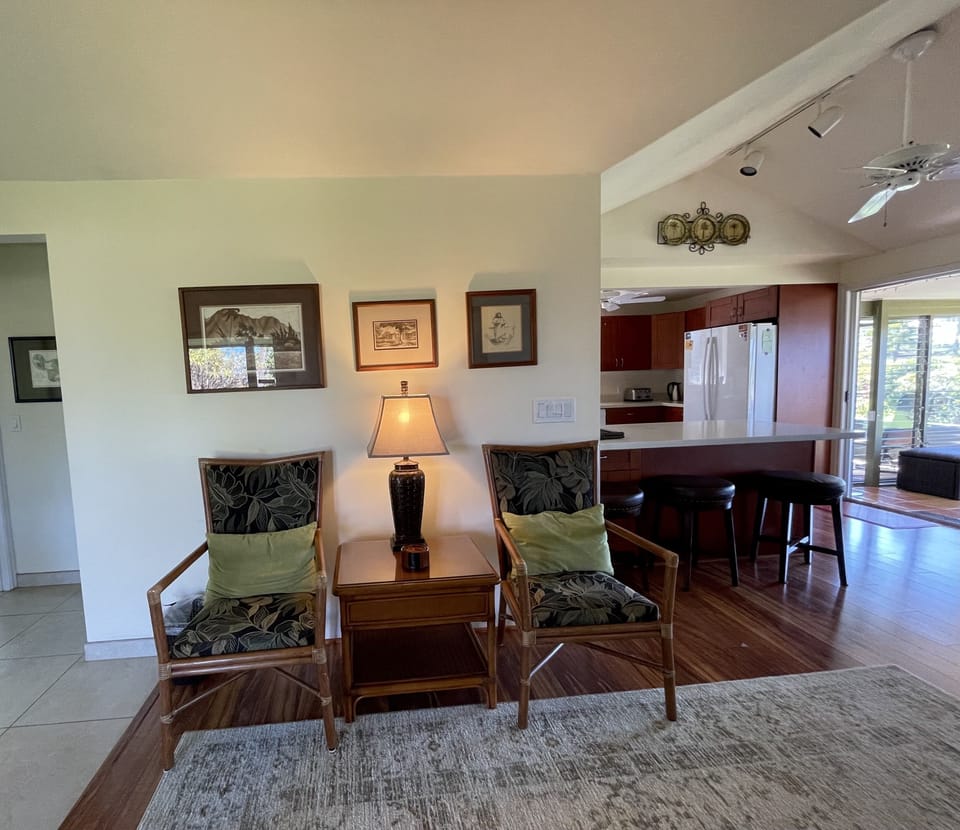 Hall to guest bath, bedrooms on left; kitchen, TV area, large lanai on right.