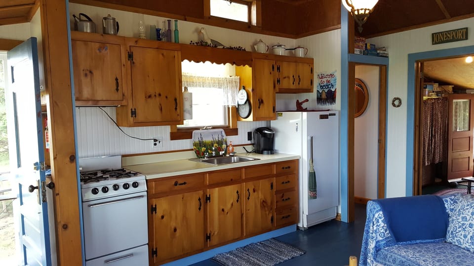 The kitchen, door to the bathroom to the right, bedroom in the back.