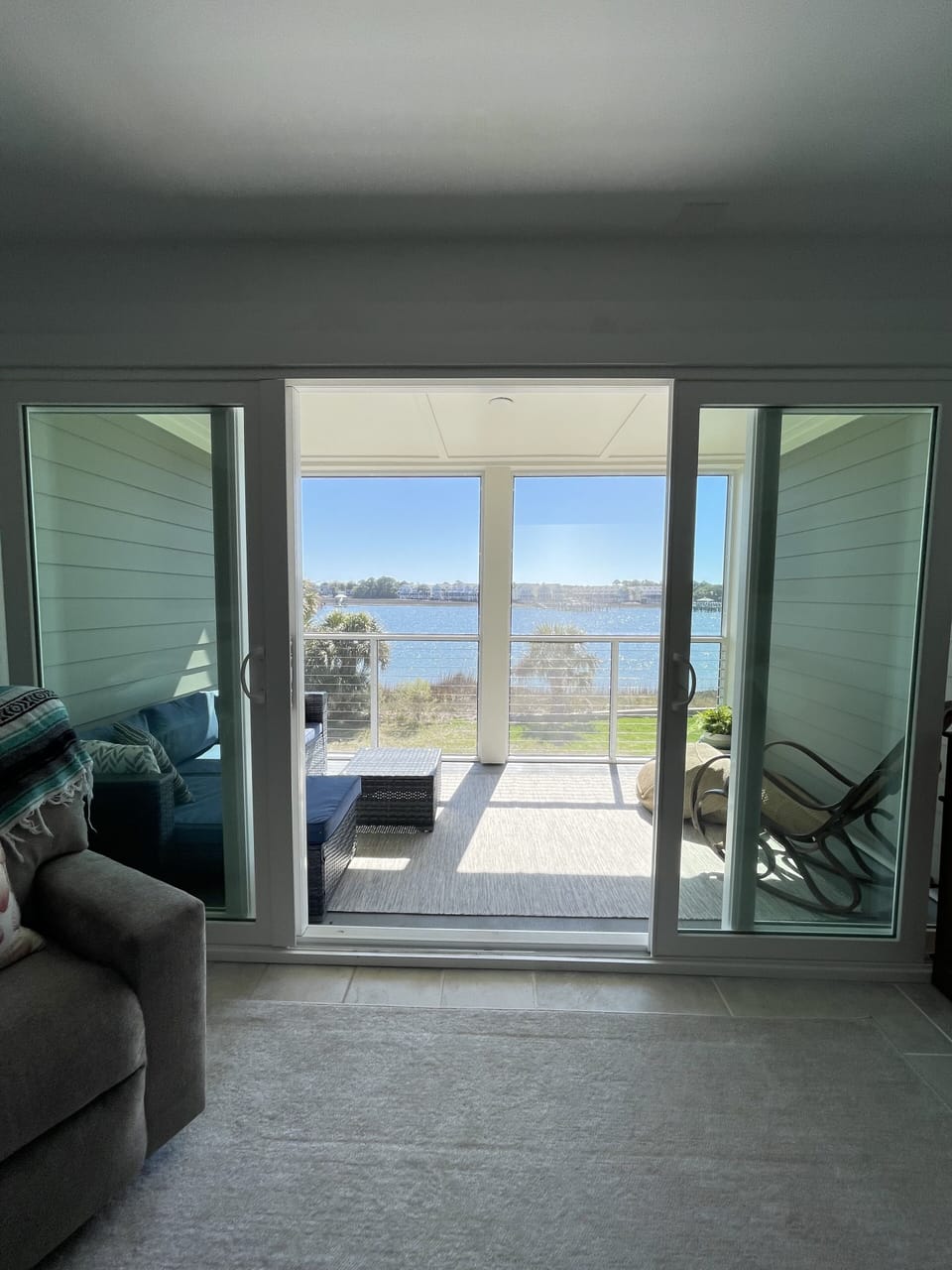 Living room with double sliding doors to screened in porch