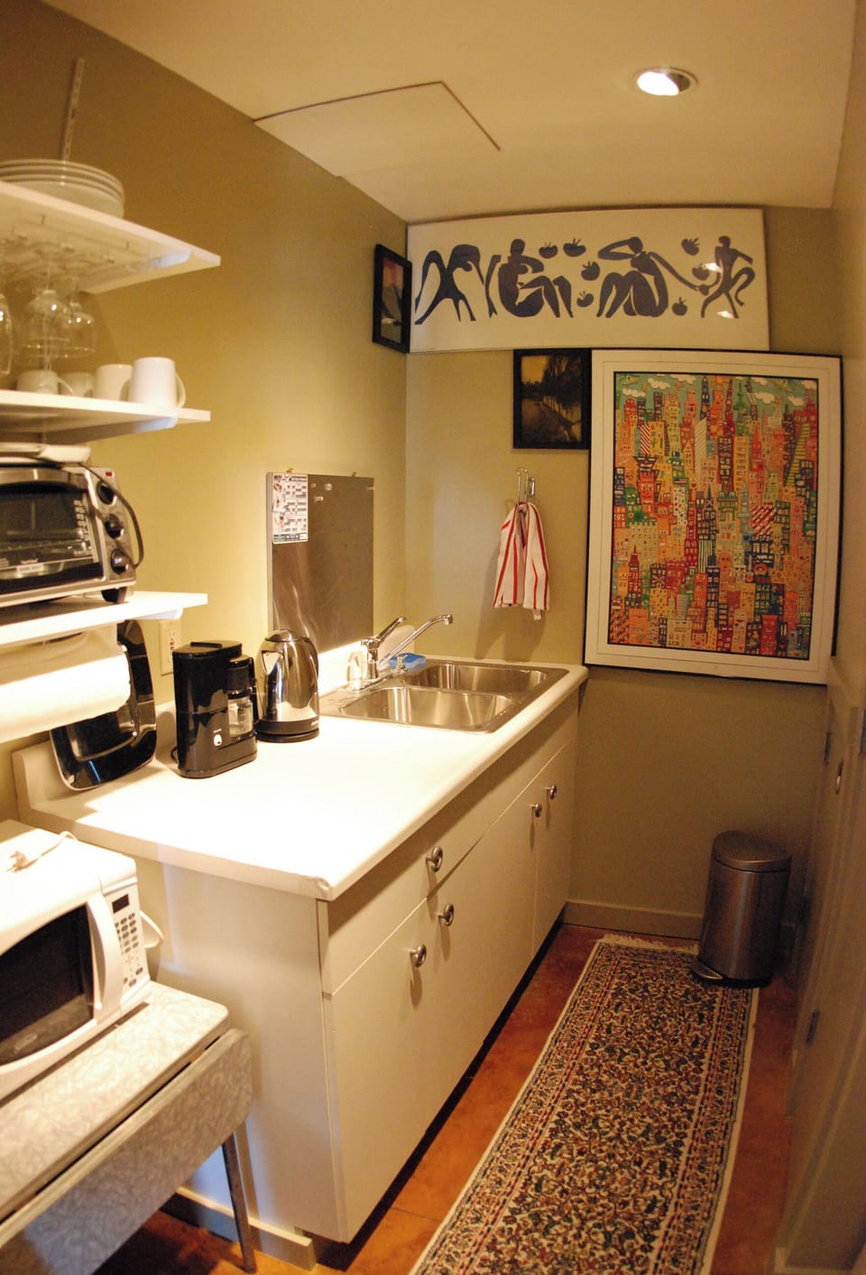 Kitchenette w/sink, refrigerator, microwave, toaster oven, coffee maker, teapot.