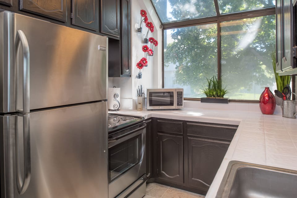 Kitchen includes cookware and dining utensils

