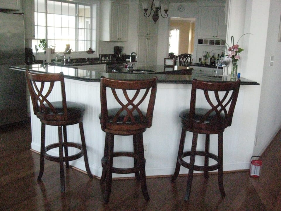 Three bar stools for extra breakfast area seating with view of island & kitchen.