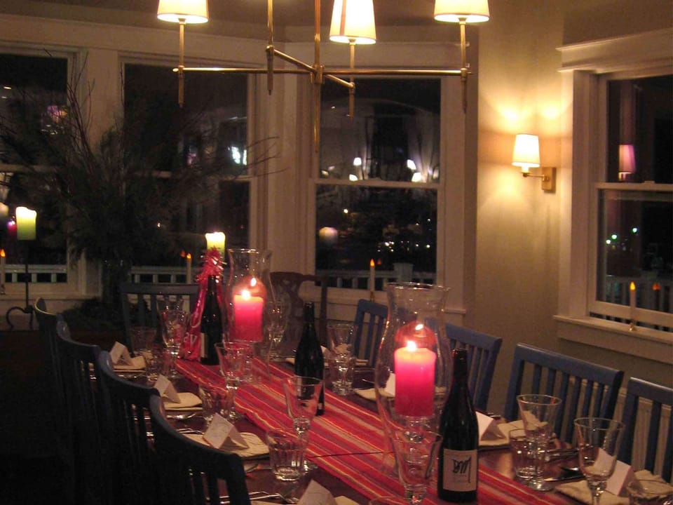 The dining room, at night, ready for a dinner party