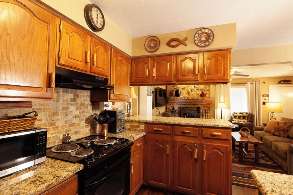 Step into your fully-equipped kitchen with granite countertops, rich wood cabinetry, and modern appliances—everything you need to prepare delicious home-cooked meals during your stay.