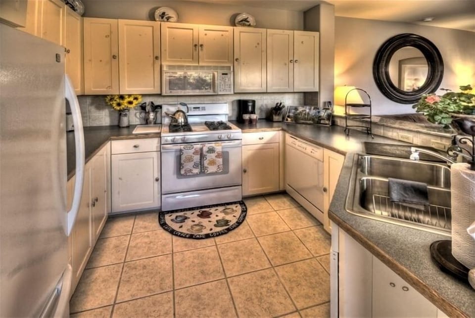 Immaculate Open Kitchen, Tile Floors, Granite Counter, Gas Stove & Microwave.