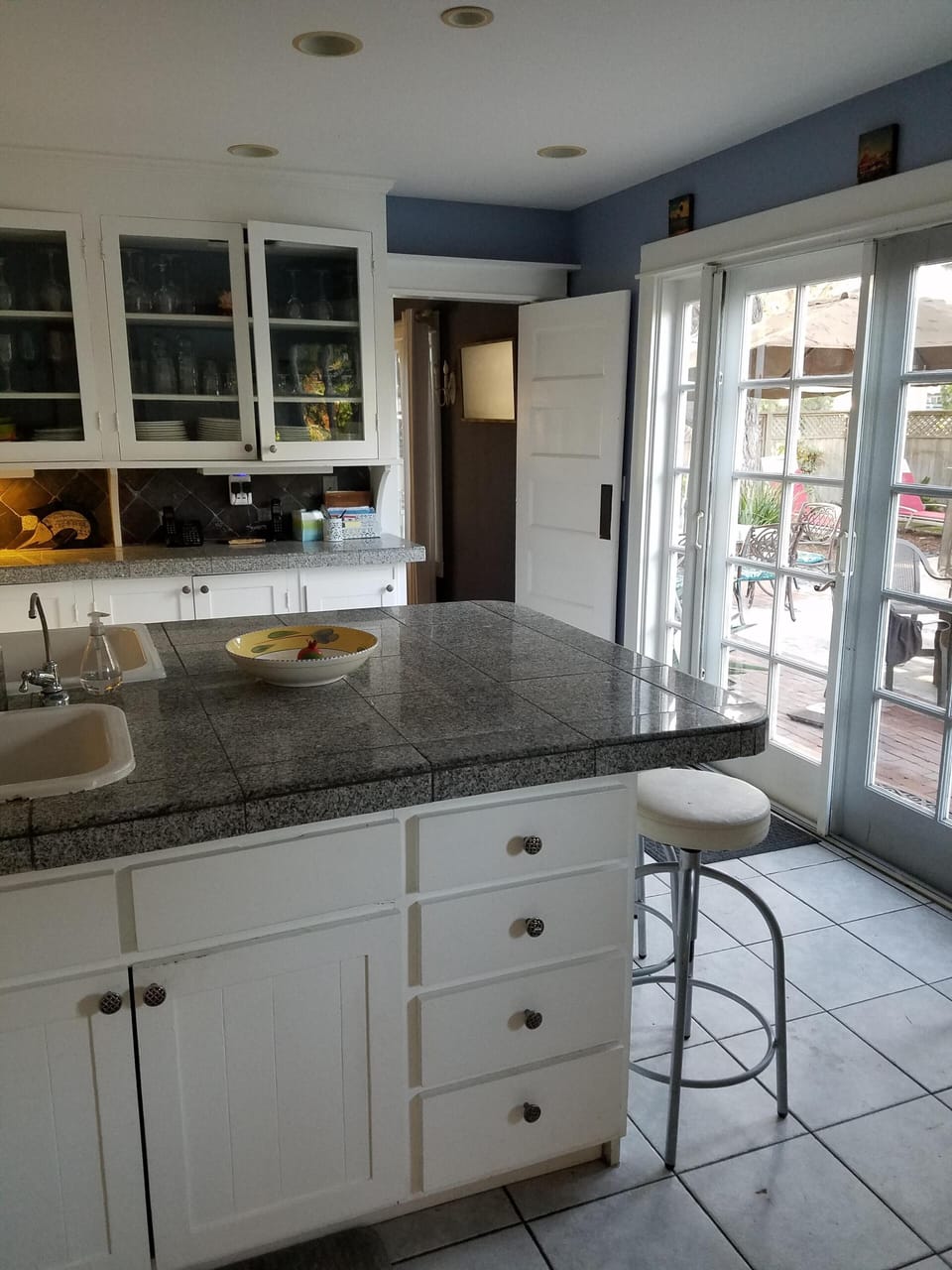 Kitchen counter seats four.  French doors open onto pool.
