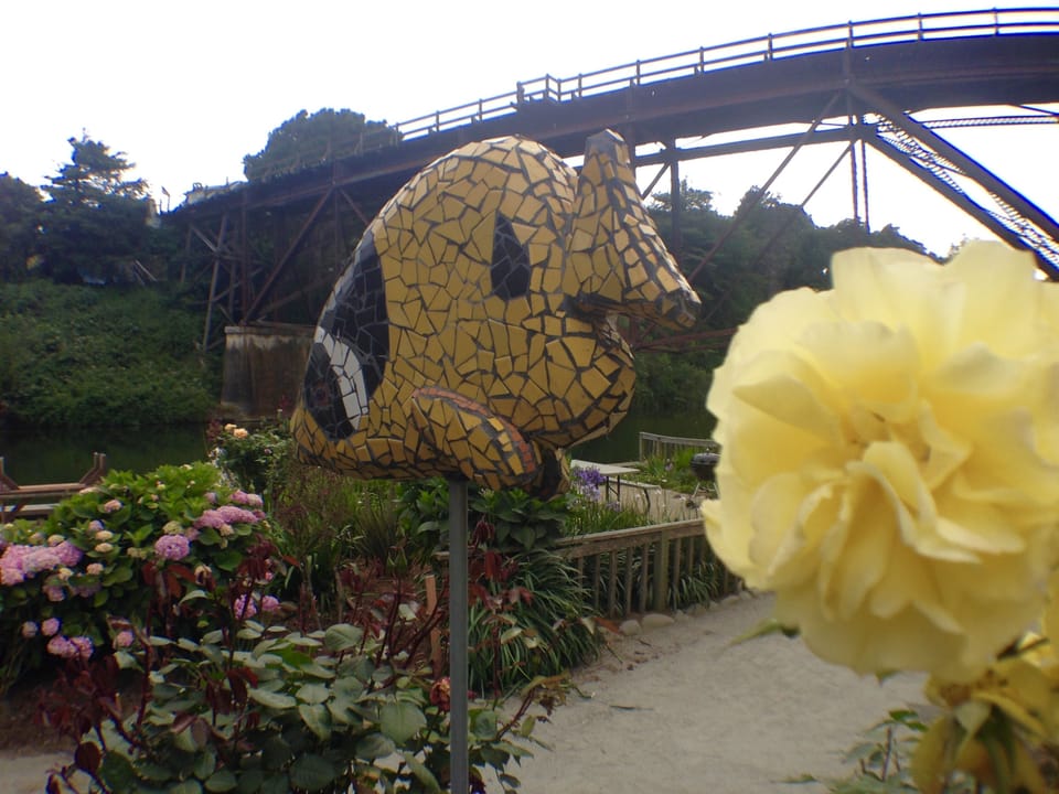 Mosaic art and beloved roses tell you this is a special place by the sea