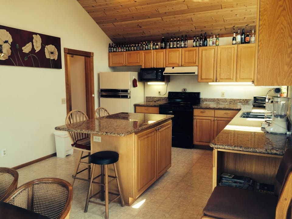 Kitchen from window corner of dining table to entry to washer and dryer