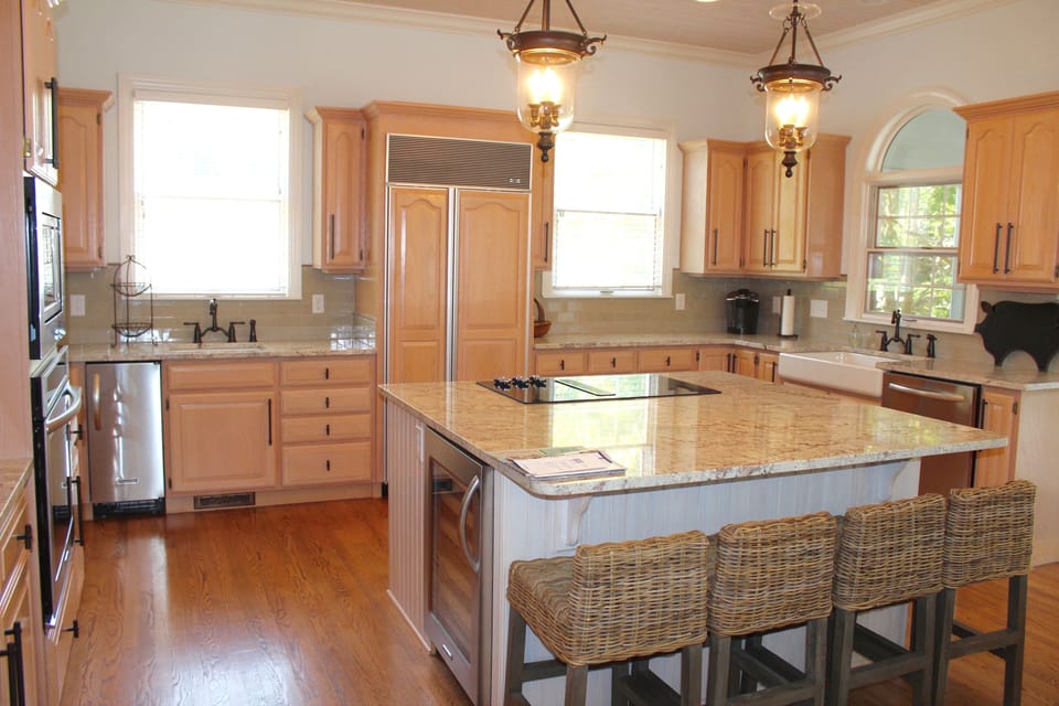 Well stocked kitchen with center island and barstools. 