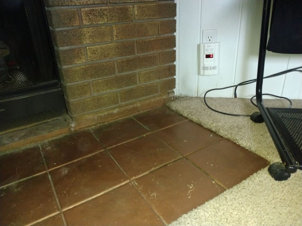 Gas detector next to fireplace.
