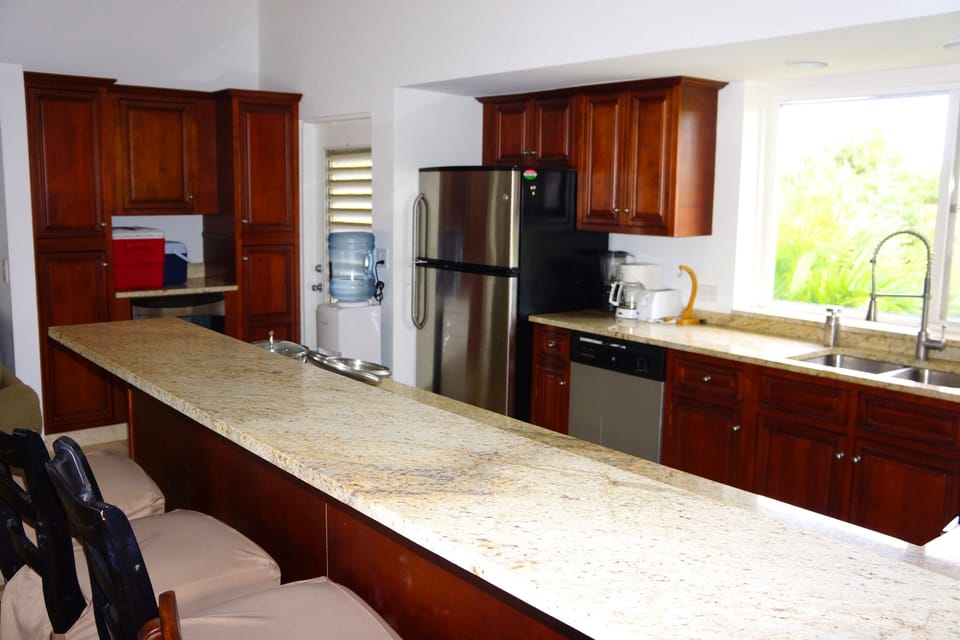Kitchen with bar, separate bar fridge and water cooler