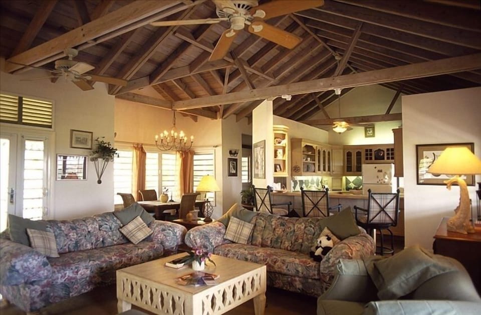 Our comfortable main Living room with dining table sofas and TV.