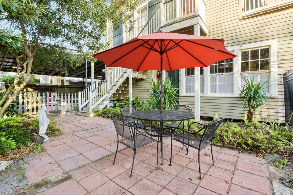 Outdoor seating in the courtyard at the rear of the house near the pool. 