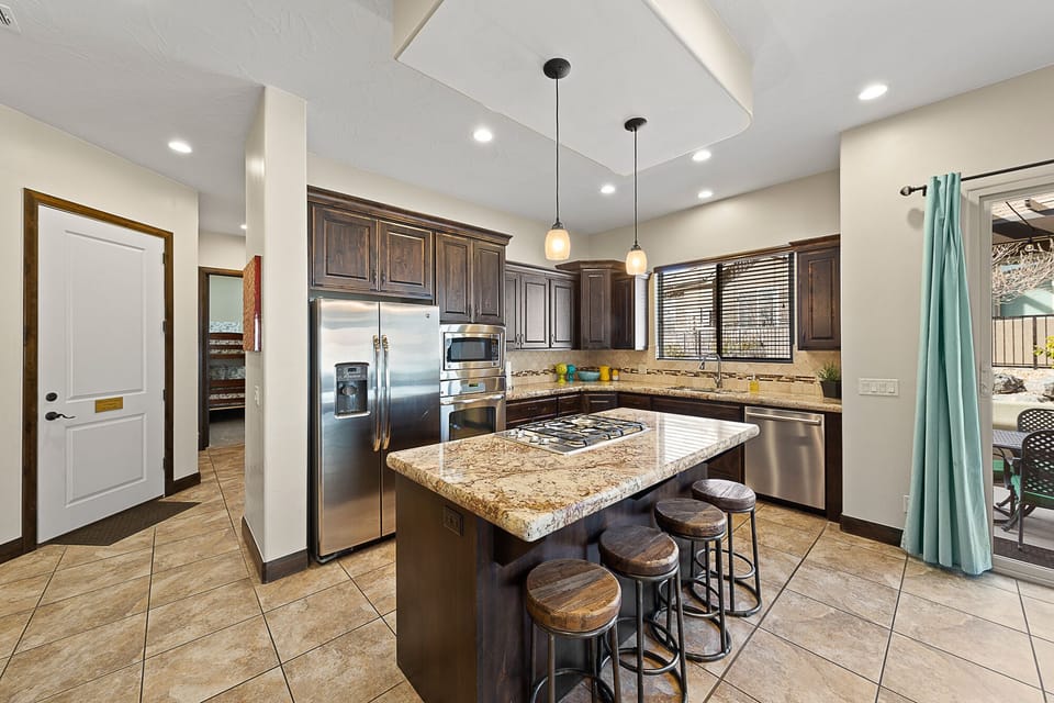Large fully stocked kitchen with open layout and gas stovetop