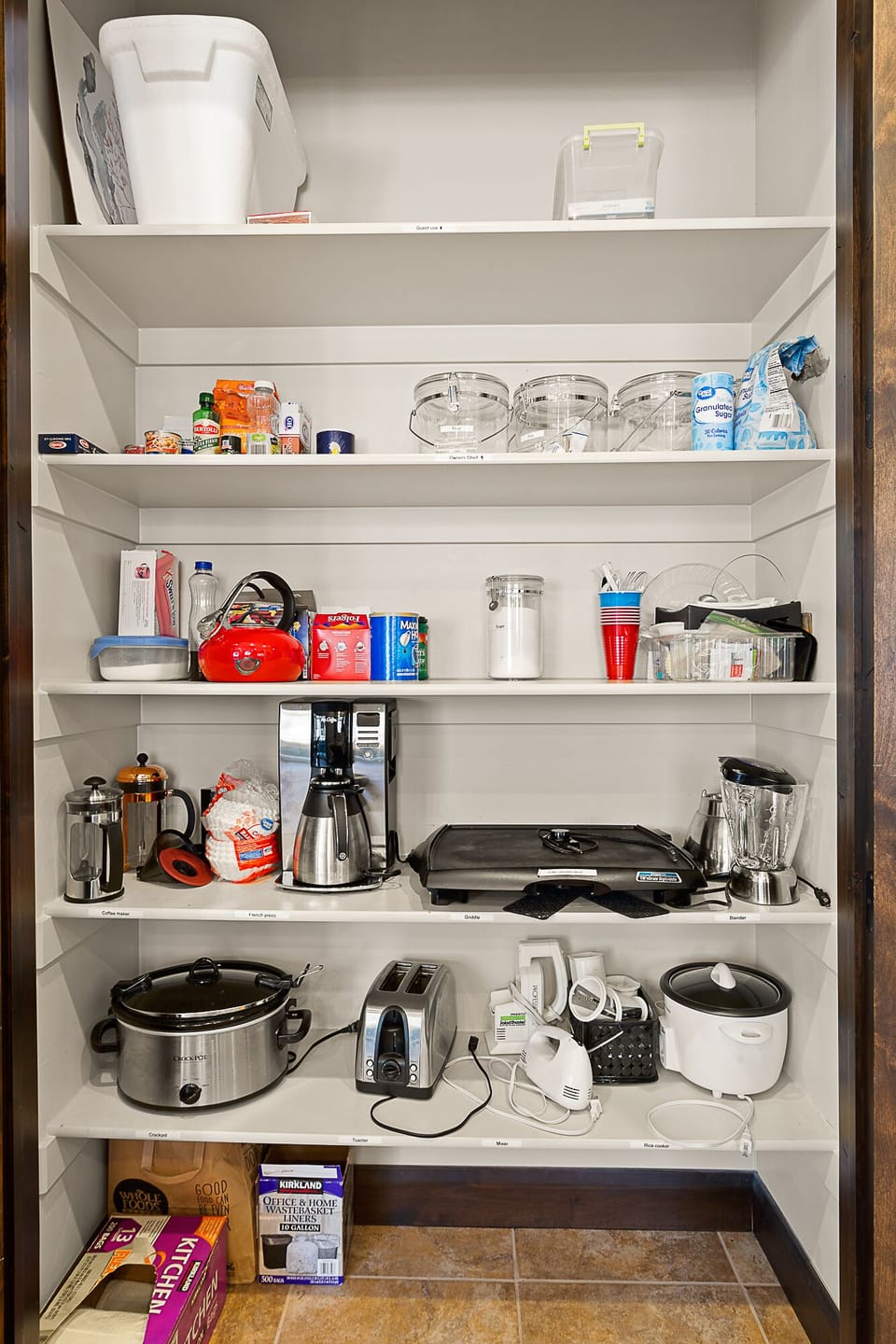 Fully stocked kitchen pantry with many desired small appliances