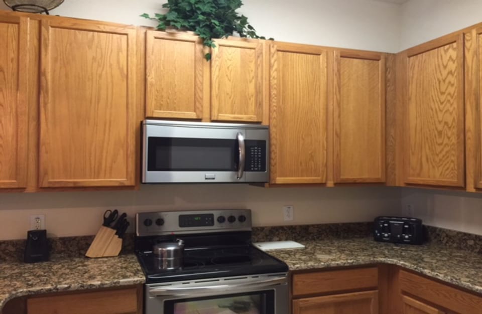 Renovated kitchen with new appliances, granite countertop, sink and faucet
