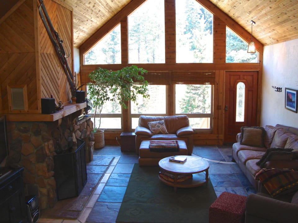Vaulted great room with wood burning fireplace and 40' TV