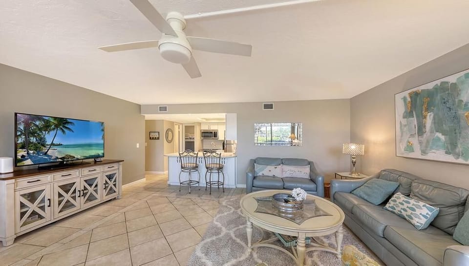 The living room features a large screen TV