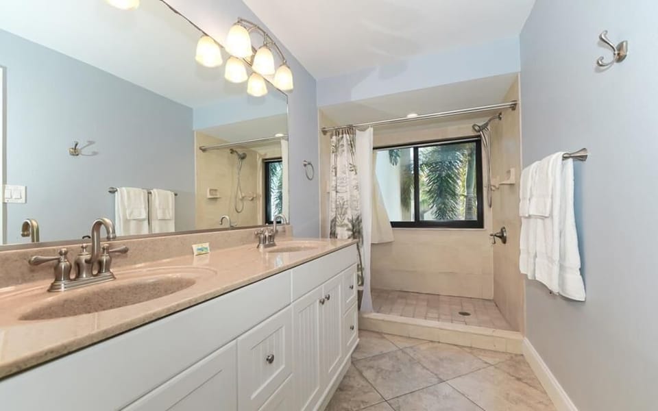 Master bathroom with dual sinks and walk in shower