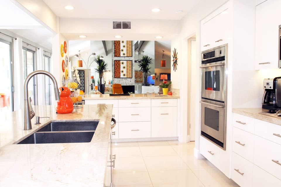 Kitchen with double oven and microwave above stove looking into Great Room
