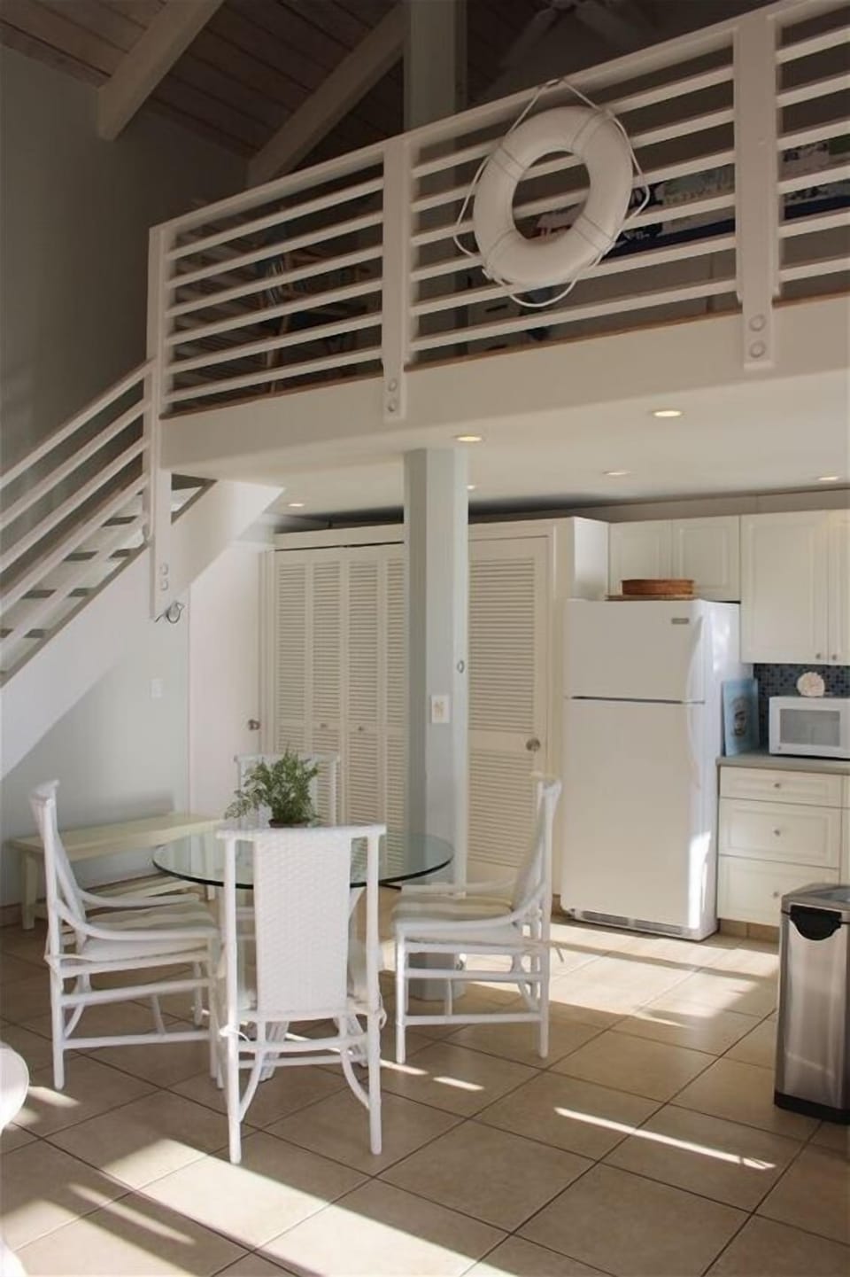 Stairs lead up to the sleeping loft above the kitchen.