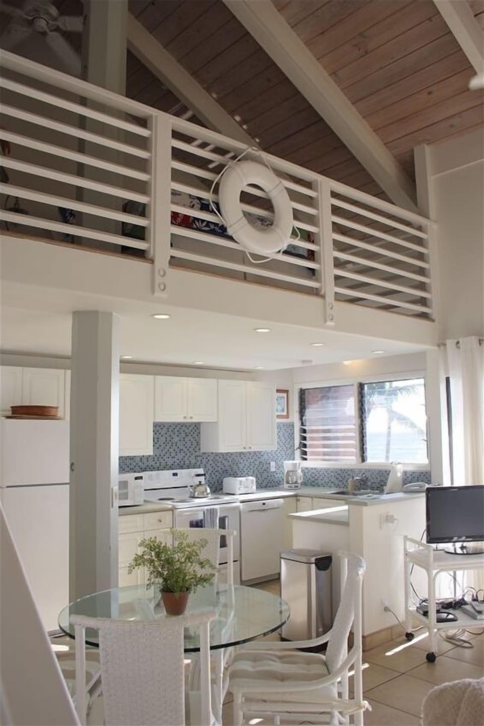 A view of the kitchen and eating area from the entranceway into the living room.