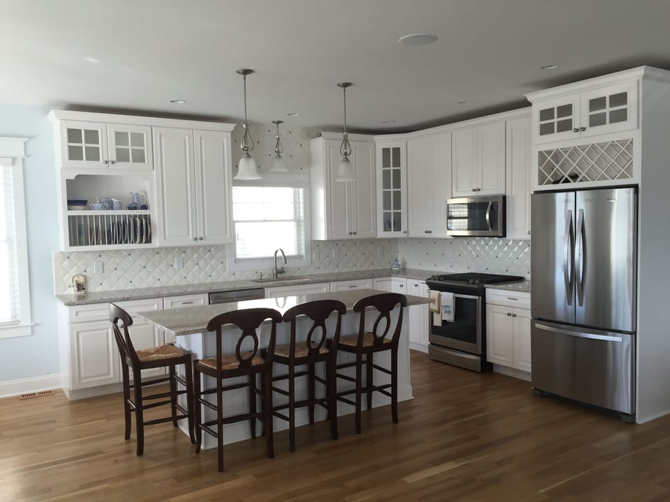 Kitchen with counter seating for four.  Gas stove, dishwasher, microwave 
