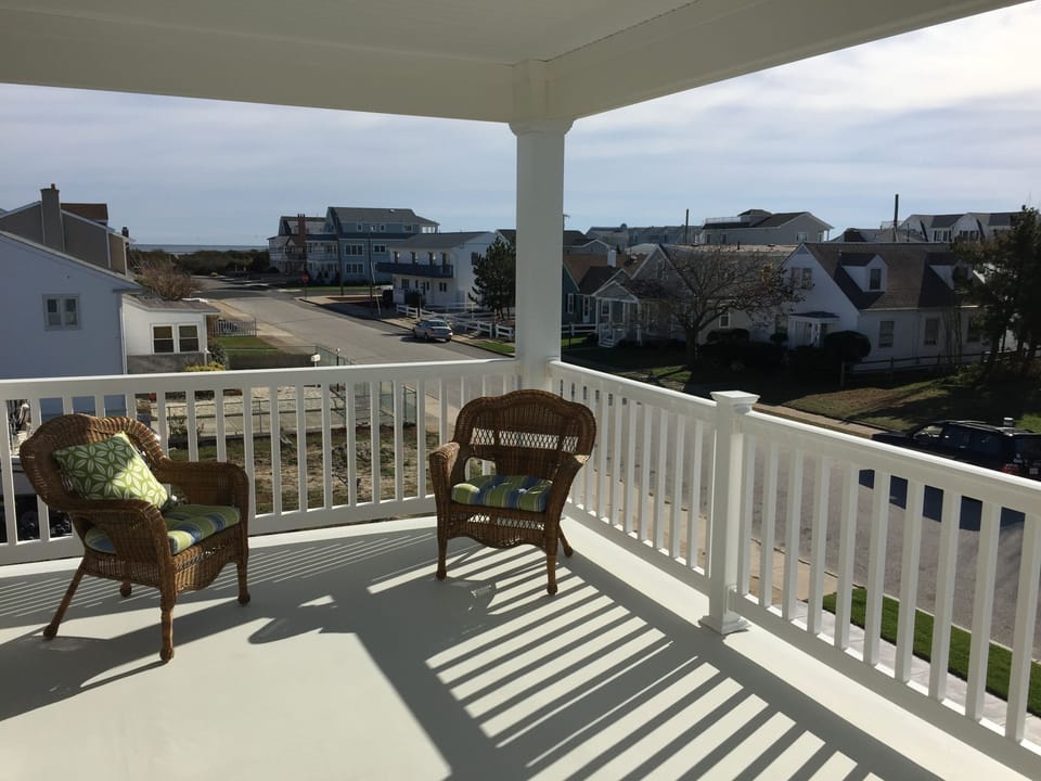 2nd floor covered deck catches afternoon breezes and provides  beach to bay view