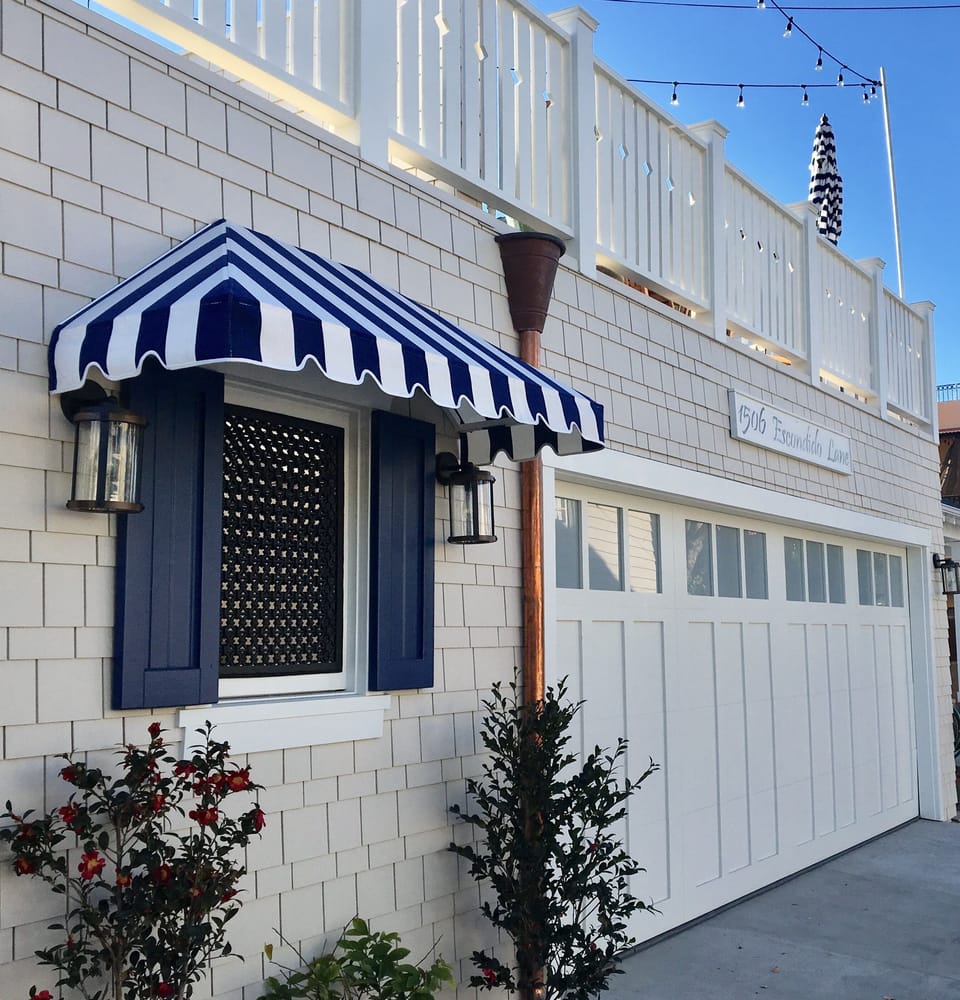 Front -- with huge SunDeck, roll up garage door with 2 covered&2 uncovered spots