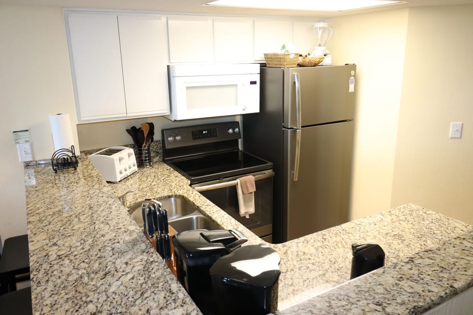Kitchen with new appliances and granite counter tops.