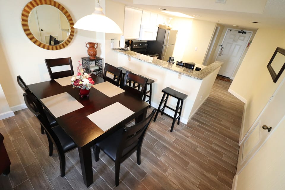 Dining and kitchen area with granite counters.