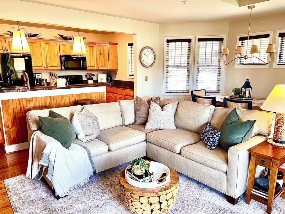 Warm, inviting living space with fireplace and mountain views just beyond.