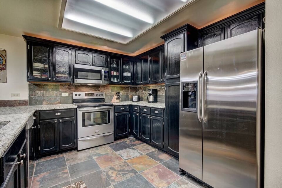 The kitchen includes a full size side by side fridge, plenty of space for your groceries.