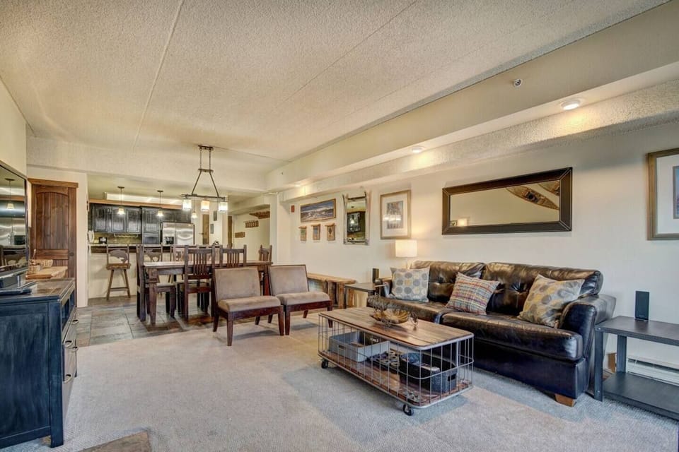 Family room leather couch pulls out to a comfortable queen memory foam mattress.