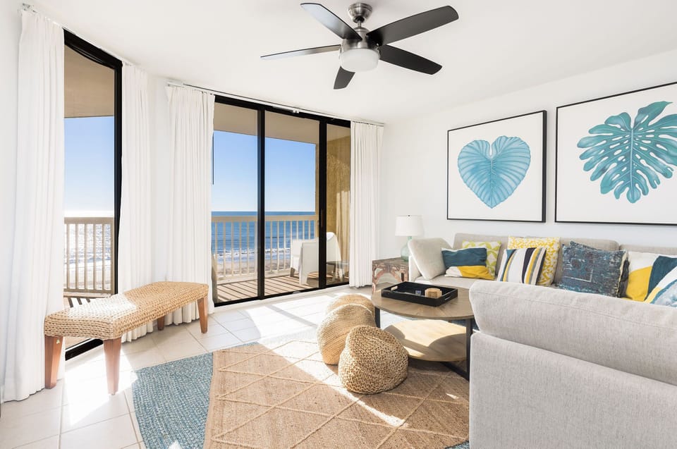 Spacious living area featuring floor-to-ceiling windows, modern furnishings, and stunning panoramic views of the Atlantic Ocean